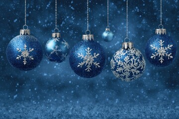 Fototapeta premium Sparkling blue Christmas ornaments with snowflakes hang against a festive winter background.