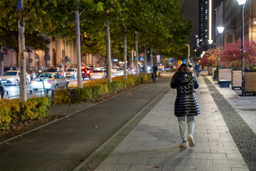 Detailed night portrait of a young girl visiting Warsaw enjoying city streets and evening atmosphere