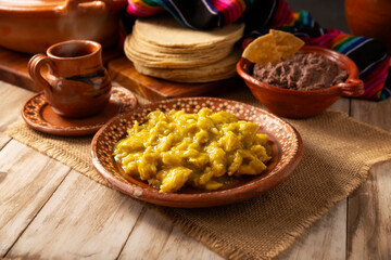 Scrambled eggs in green sauce. A typical Mexican breakfast of scrambled eggs bathed in spicy green sauce, usually accompanied by beans and pot coffee.