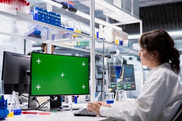 Isolated screen PC used by research facility specialist evaluating genetic markers associated with disease risk. Cytotechnologist studies DNA strand mapping with genomics analysis program on mockup PC