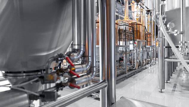 Brewery food industrial production concept. Large reservoirs or tanks in modern beer factory, Pipes stainless steel brewing equipment - Powered by Adobe