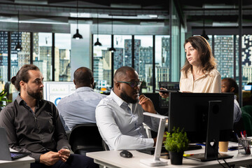 Diverse employees exchanging insights and new ideas to meet objectives, doing report sharing and...