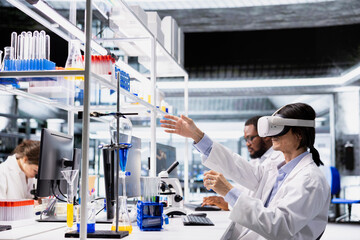 Laboratory chemical engineer using virtual reality tech to process DNA patient data for clinical research. Lab worker wearing VR goggles gear to do genetic analysis diagnostics