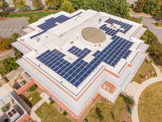 Sunny Daytime Drone Images of the Roof of a Commercial Building Featuring Solar Panels