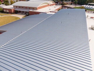 Fototapeta premium Sunny Daytime Drone Images of a New Commercial Building With A Large Standing Seam Metal Roofing System