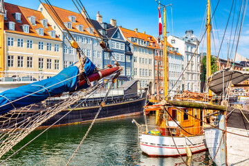 Copenhagen iconic view. Famous old Nyhavn port in the center of Copenhagen, Denmark during summer...