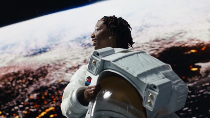 Smiling cosmonaut seeking extraterrestrial life on Mars, excited to land. Joyous woman working on spaceship doing Martian surface research, elated by amazing planet habitat, camera B