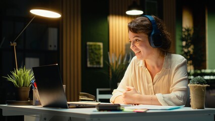 Focused consultant takes notes during executive board meeting video call, extracting essential...