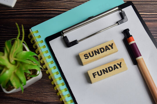 Sunday funday on stacked wooden cubes on the table. Business and finance concept