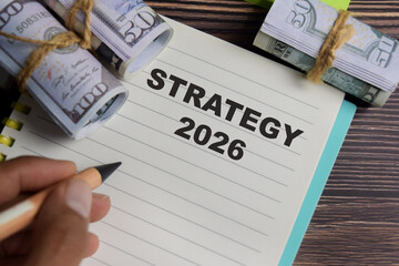 Concept of strategy 2026 write on book with keywords isolated on Wooden Table.