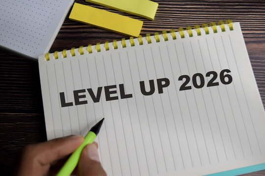 Concept of level up 2026 write on book with keywords isolated on Wooden Table.