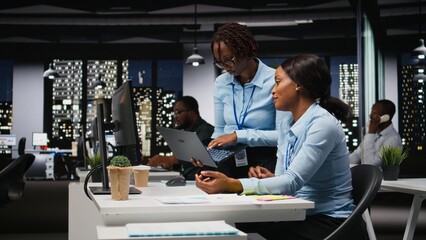 Business manager and analyst monitoring data insights at the workspace, utilizing analytics to plan...