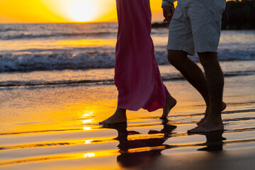 Couple in love walking on the beach at sunset. Love concept