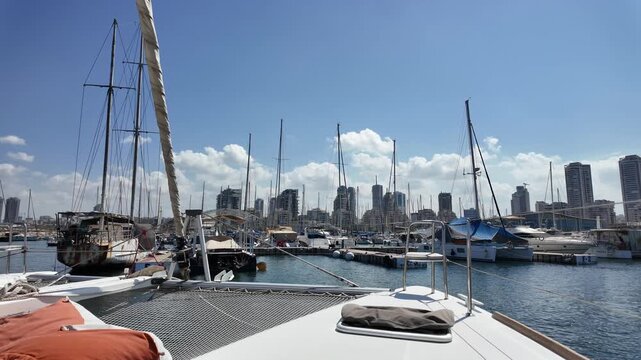 Luxury yacht anchored in a peaceful marina near Ashdod Port, Israel. Calm sea, blue sky, and modern harbor scenery along the Mediterranean coast.