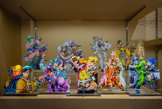 tokyo, shibuya - sep 12 2025: Colorful japanese acrylic standees of  Jojo's Bizarre Adventure manga and anime characters from all eight arcs are neatly arranged on a shelf, capturing the iconic poses.