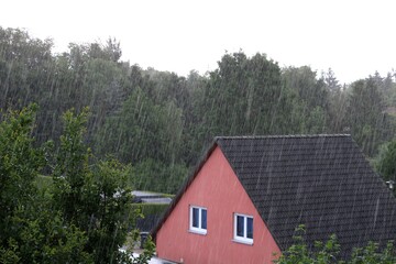Heavy rain over suburban house, summer shower