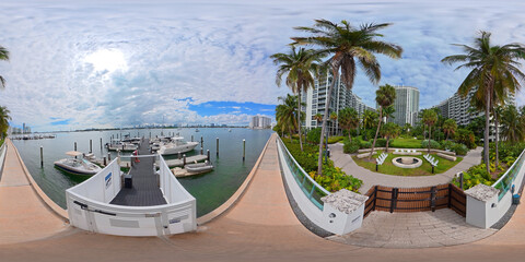 Miami Beach 360 scene. VR equirectangular photo of condominiums on Biscayne Bay. Marina dock and palms by a pedestrian walkway