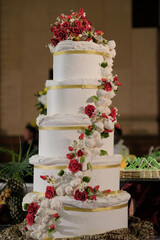 A large wedding cake with luxury decorations represents the splendor of the event for a happy couple.