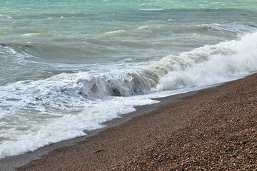 Sea waves on the sandy beach, English Channel, Brighton, UK