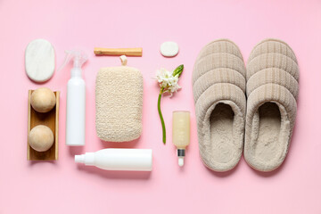 Different bath supplies for foot massage, slippers and flower on pink background