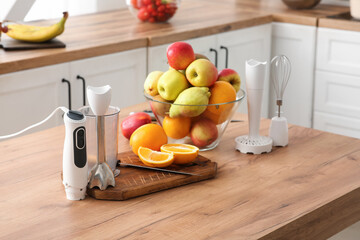 Modern blender and fresh fruits on table in kitchen