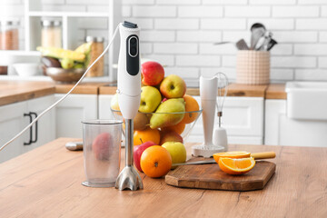 Modern blender and fresh fruits on table in kitchen