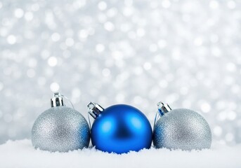 Christmas ornaments in snow with a blurred, sparkling background