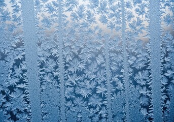 Intricate patterns of frost crystals on a window pane in winter