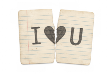 Torn paper pieces forming a broken heart with i love you revealing concepts of heartbreak, separation, and breakup