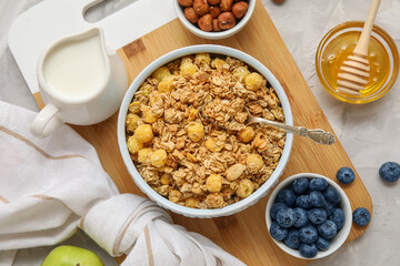 Composition with bowls of granola and ingredients on grey grunge background, closeup