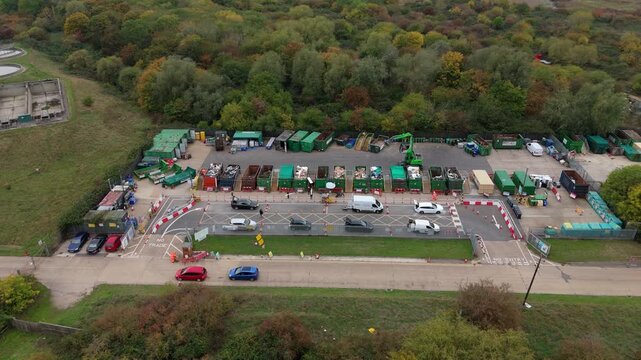 Aerial drone view of domestic waste refuse recycling centre, garbage and rubbish being dropped off in skips near Canvey Island UK