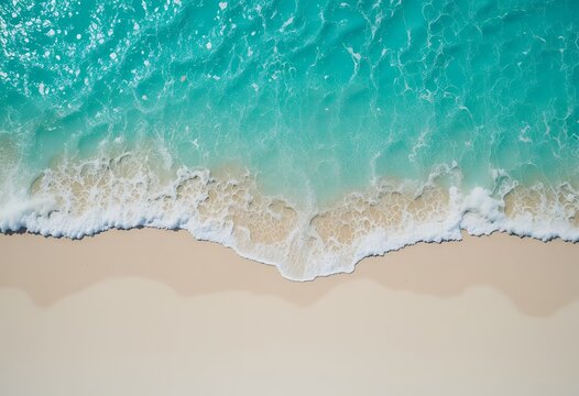 aerial view of ocean waves gently washing over a pristine sandy shoreline depicting serene beach - Powered by Adobe