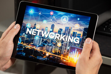 a male hands holding a tablet with the networking word over a technology concept