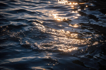 Fototapeta premium Close up of rippling water reflecting morning sunlight, creating serene and peaceful atmosphere with gentle waves and shimmering golden highlights on surface