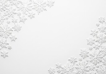 Decorative white snowflakes arranged on a clean, bright, white background
