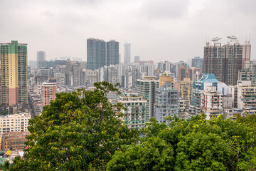 Top view on the residential district of Macau behind the trees
