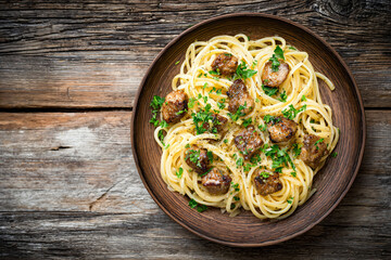 Spaghetti with Meat and Herbs on Wooden Table
