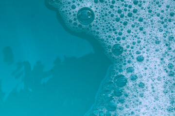 Foamy blue water surface with bubbles.
