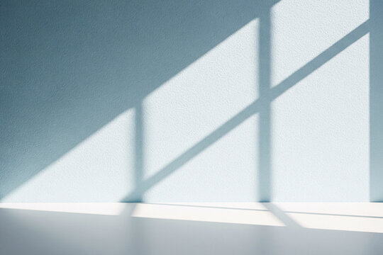 Soft window light casting elegant geometric shadows on textured blue wall for modern interior design or stylish product photography