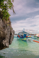 Many boats docking on the beautiful beach in Coron Island, Philippines