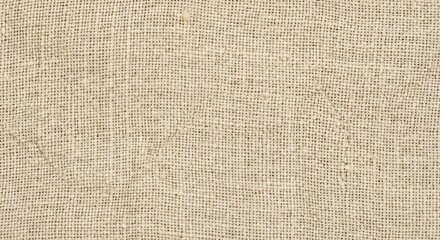 Closeup of beige burlap fabric with woven pattern and subtle variations in texture
