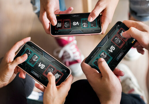 Group Of Diverse Friends Playing Game On Mobile Phone