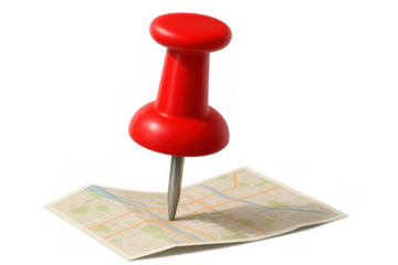Red pushpin marking specific location on folded city map, indicating destination or travel route