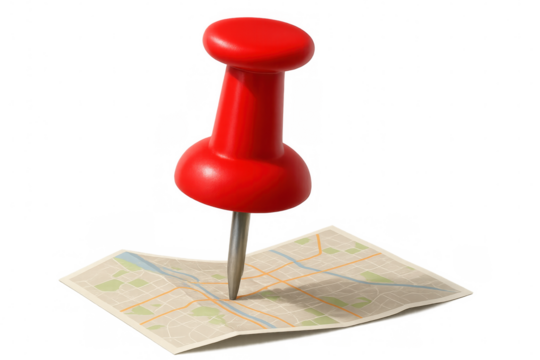 Red pushpin marking specific location on folded city map, indicating destination or travel route