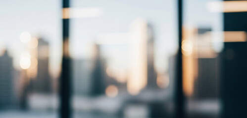 Blurry city view through a wide glass window with warm bokeh lights glowing from tall buildings at night, evoking a peaceful and dreamy urban mood with soft reflections.