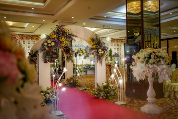 design wedding ceremony entrance corridor decoration with white roses in indonesia