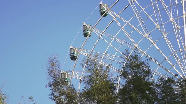 Aerial Drone View of Star City Ferris Wheel in Pasay City Metro Manila, Philippines &mdash; 4K Footage Showing Carnival Amusement Park and Iconic Ferris Wheel Attraction at Sunrise