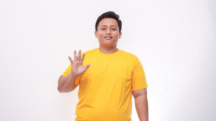 Young Asian fat men gesturing sign language on isolated background