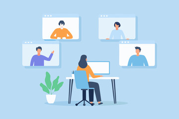 Woman working from home attending a video conference call with colleagues on her computer