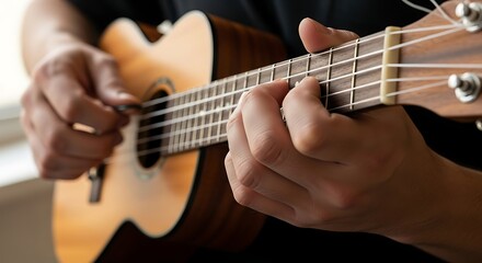 Obraz premium Close up of hands playing a ukulele, focusing on the strings and frets.